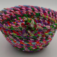 This view shows both the inside and outside of the basket with its big knot for embellishment.  This view shows both the inside and outside of the basket with its big knot for embellishment.